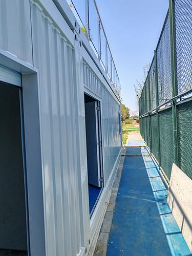 corrugated shipping container houses for constructing a two-storey villa next to a tennis court